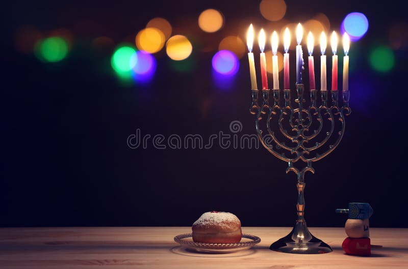 religion image of jewish holiday Hanukkah background with menorah traditional candelabra, spinning top and doughnut. religion image of jewish holiday Hanukkah background with menorah traditional candelabra, spinning top and doughnut.
