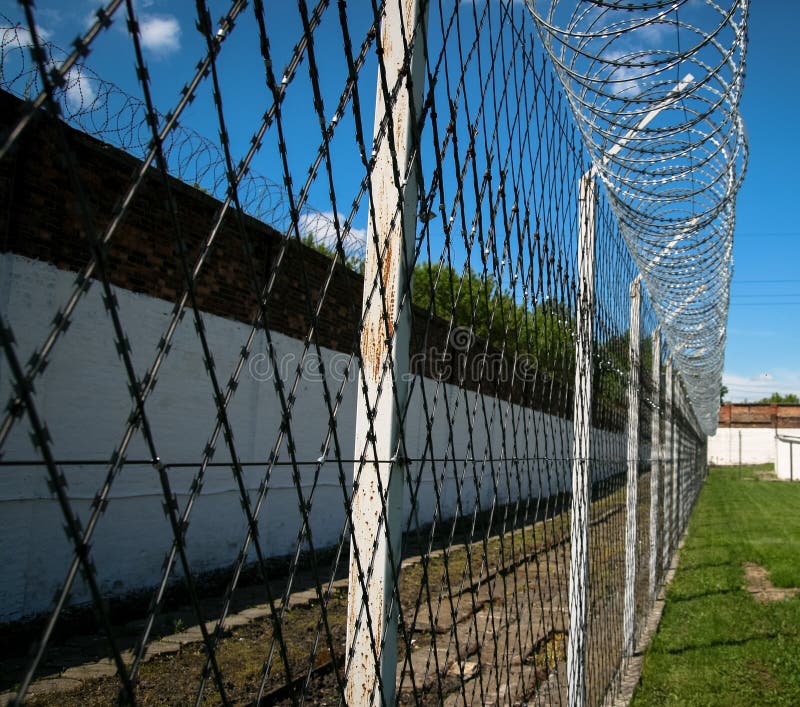 Barbed-wire and brick walls in order to secure prison area. Barbed-wire and brick walls in order to secure prison area.