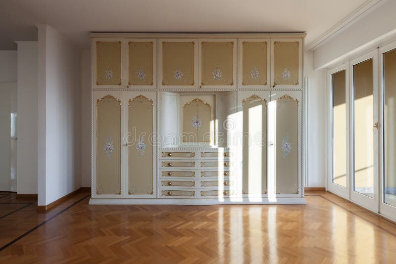 Interior of an house, empty room with a period closet, parquet floor. Interior of an house, empty room with a period closet, parquet floor