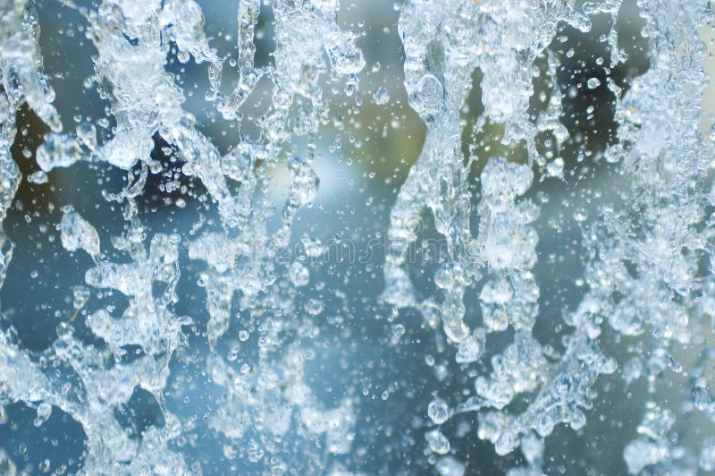 Water drops splatter from a fountain. Water drops splatter from a fountain.