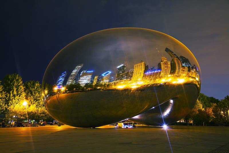 CHICAGO - MAY 18: Cloud Gate sculpture in Millenium park on May 18, 2013 in Chicago, IL. It's a public sculpture by Indian-born British artist Anish Kapoor, is the centerpiece of the AT&T Plaza in Millennium Park within the Loop community area of Chicago, Illinois, United States. CHICAGO - MAY 18: Cloud Gate sculpture in Millenium park on May 18, 2013 in Chicago, IL. It's a public sculpture by Indian-born British artist Anish Kapoor, is the centerpiece of the AT&T Plaza in Millennium Park within the Loop community area of Chicago, Illinois, United States.