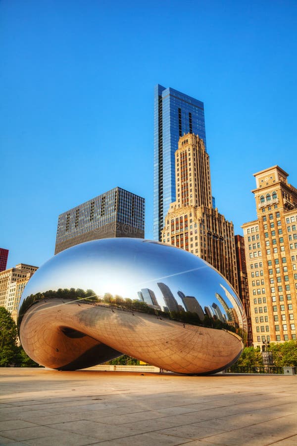 CHICAGO - MAY 18: Cloud Gate sculpture in Millenium park on May 18, 2013 in Chicago, IL. It's a public sculpture by Indian-born British artist Anish Kapoor, is the centerpiece of the AT&T Plaza in Millennium Park within the Loop community area of Chicago, Illinois, United States. CHICAGO - MAY 18: Cloud Gate sculpture in Millenium park on May 18, 2013 in Chicago, IL. It's a public sculpture by Indian-born British artist Anish Kapoor, is the centerpiece of the AT&T Plaza in Millennium Park within the Loop community area of Chicago, Illinois, United States.