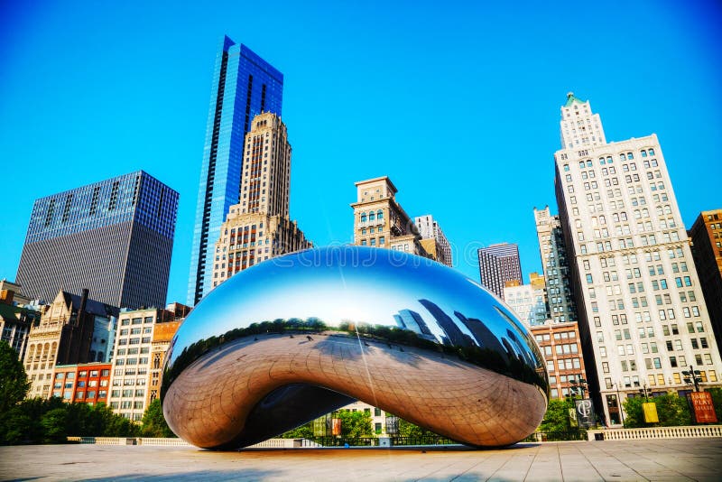 CHICAGO - MAY 18: Cloud Gate sculpture in Millenium park on May 18, 2013 in Chicago, IL. It's a public sculpture by Indian-born British artist Anish Kapoor, is the centerpiece of the AT&T Plaza in Millennium Park within the Loop community area of Chicago, Illinois, United States. CHICAGO - MAY 18: Cloud Gate sculpture in Millenium park on May 18, 2013 in Chicago, IL. It's a public sculpture by Indian-born British artist Anish Kapoor, is the centerpiece of the AT&T Plaza in Millennium Park within the Loop community area of Chicago, Illinois, United States.