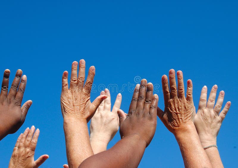 African black and caucasian white hands of four ladies reaching out to the sky symbolizing world freedom for women. African black and caucasian white hands of four ladies reaching out to the sky symbolizing world freedom for women