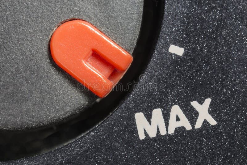Macro close up view of vintage tape machine volume dial set to MAX. Macro close up view of vintage tape machine volume dial set to MAX