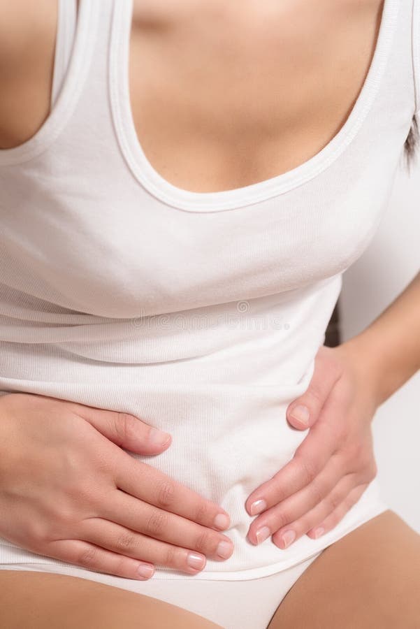 Woman with acute abdominal pain stock images