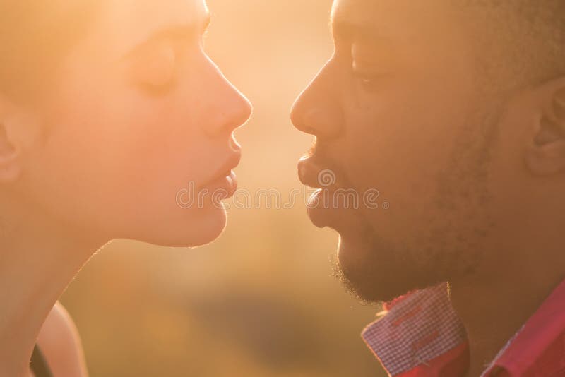 Rapper culture concept. Black macho with beard wears rapper cap and looks  handsome. Man on calm face with sensual big lips, close up. Man with beard  and mustache indoor, jalousie background Stock