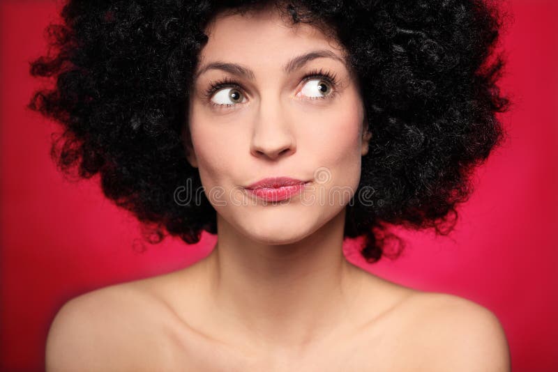 Young woman over red background. Woman doubtful looking stock images, royalty-free photos and pictures