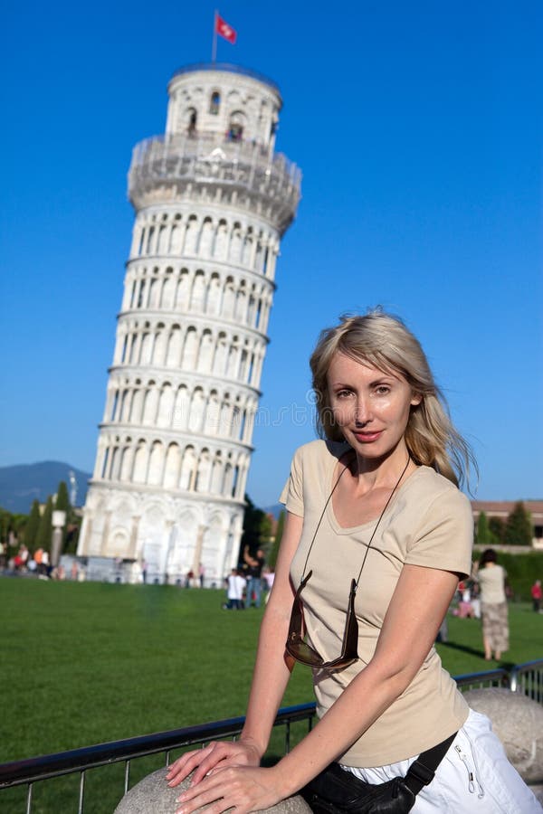 Woman against a falling tower in Pisa