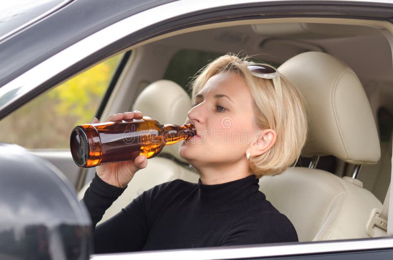 Woman Alcoholic Drinking As She Drives The Car Royalty Free Stock Photo