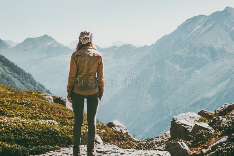 Woman alone standing in mountains wander landscape