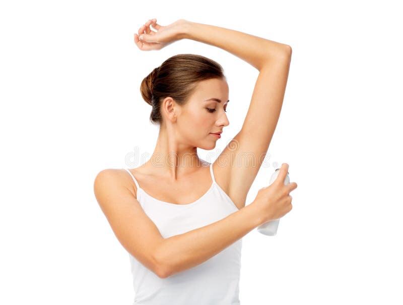 Beauty, hygiene, bodycare and people concept - beautiful young woman applying antiperspirant or spray deodorant over white background. Beauty, hygiene, bodycare and people concept - beautiful young woman applying antiperspirant or spray deodorant over white background