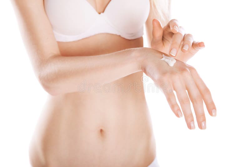 Woman applies cream on her hands isolated stock photo Woman applies cream on her hands isolated stock photo
