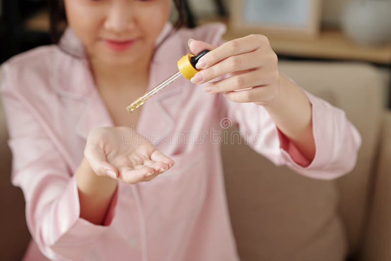 Woman applying brightening essence