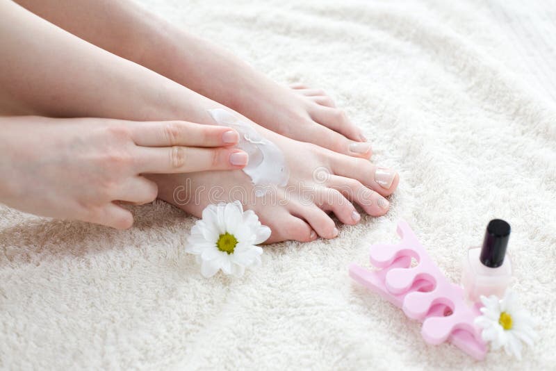 Woman applying cream on her feet royalty free stock photos