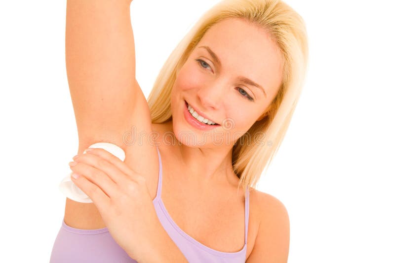 Woman applying deodorant under her armpits