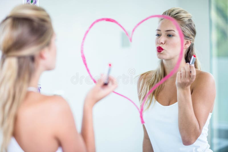 Woman applying lipstick