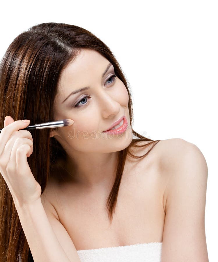 Woman putting on make up with brush