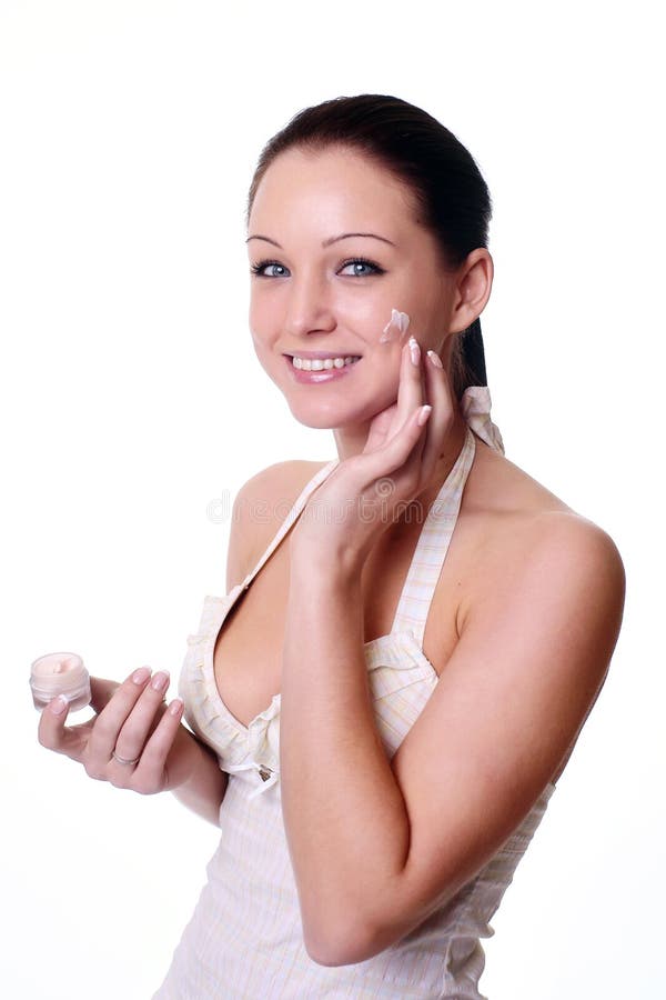 Woman Applying Moisturizer Cream on Face. Stock Photo Image of