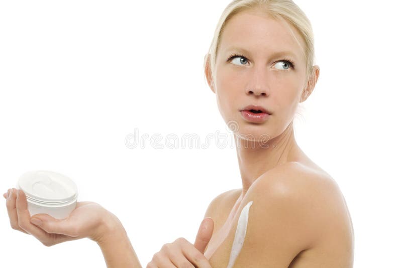 Woman applying moisturizing lotion on the body