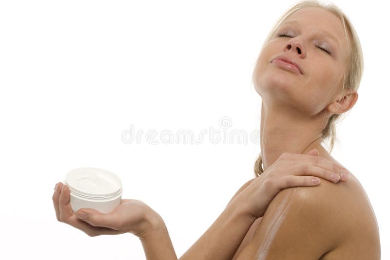 Woman applying moisturizing lotion on the body