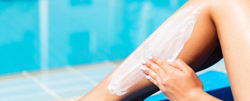 Woman is applying sunscreen on her tanned legs by the swimming pool. Sun Protection Factor in vacation, concept stock photos Woman is applying sunscreen on her tanned legs by the swimming pool. Sun Protection Factor in vacation, concept stock photos
