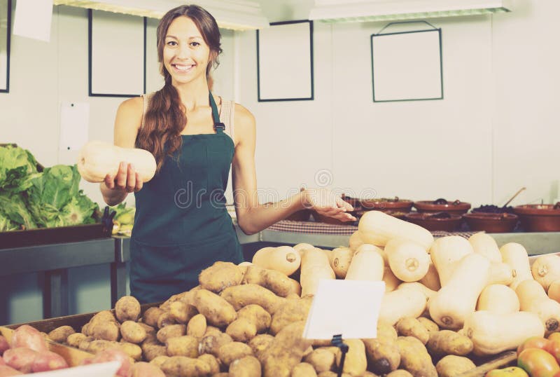 Woman in apron selling small decorative pumpkins royalty free stock image Woman in apron selling small decorative pumpkins royalty free stock image