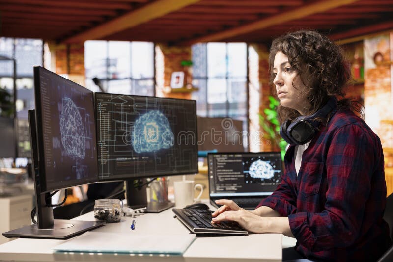 Woman in artificial intelligence focused startup office coding stock photography