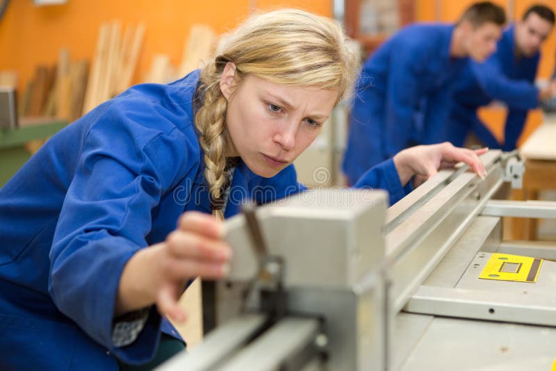 Woman As Apprentice for Carpentry Learning and Working Stock Photo