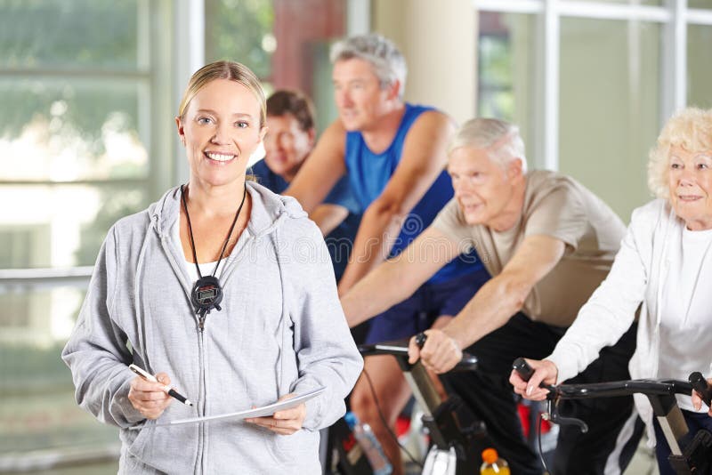 Woman as a trainer for seniors in the fitness center stock photography Woman as a trainer for seniors in the fitness center stock photography
