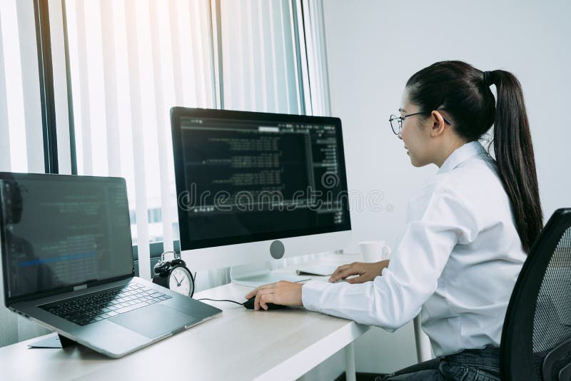 Woman asian software developers are analyzing together about the code written into the program on the computer in office room stock photos