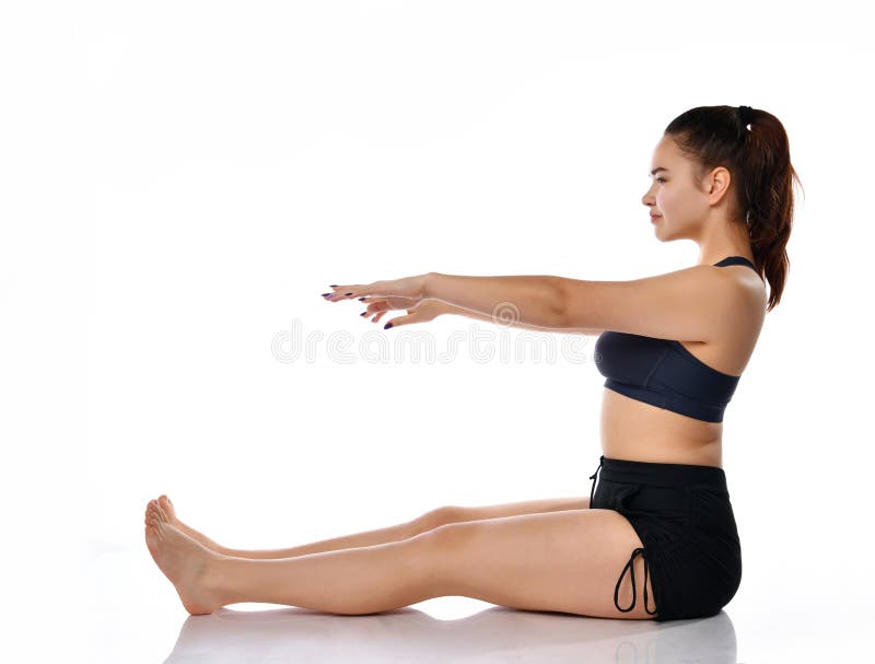 Woman athlete sitting sideways on a white background with outstretched arms and legs. Female athlete dressed in a sports uniform sits sideways on a white stock image Woman athlete sitting sideways on a white background with outstretched arms and legs. Female athlete dressed in a sports uniform sits sideways on a white stock image