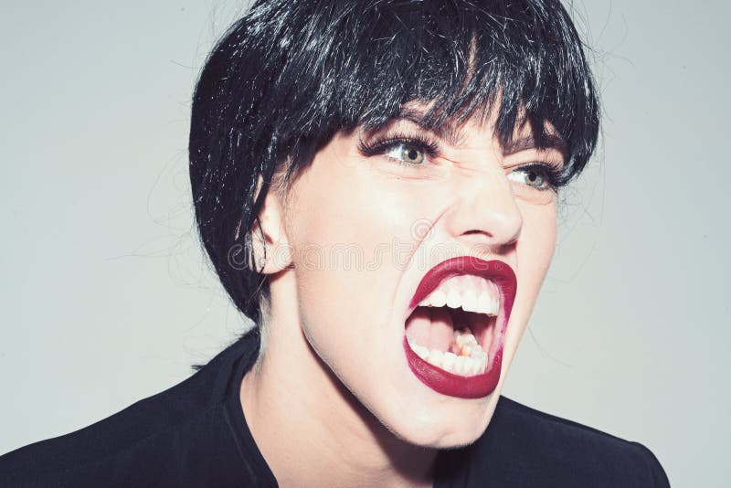 Woman with attractive red lips shouting, close up. Angry boss concept. Girl on scandalous shouting face wears formal royalty free stock photo Woman with attractive red lips shouting, close up. Angry boss concept. Girl on scandalous shouting face wears formal royalty free stock photo