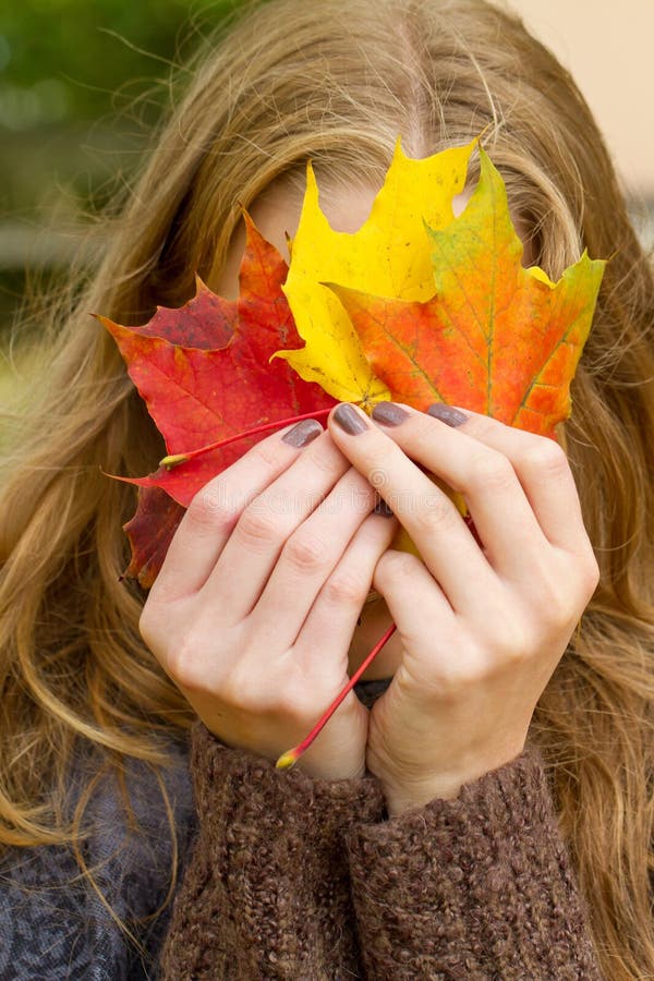 Woman with autumn leaf stock image. Image of colorful 42936267