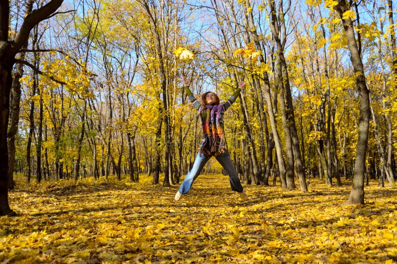 Woman among the autumn leaves