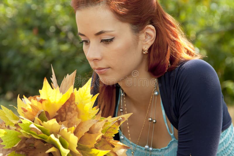 Woman with autumn leaves