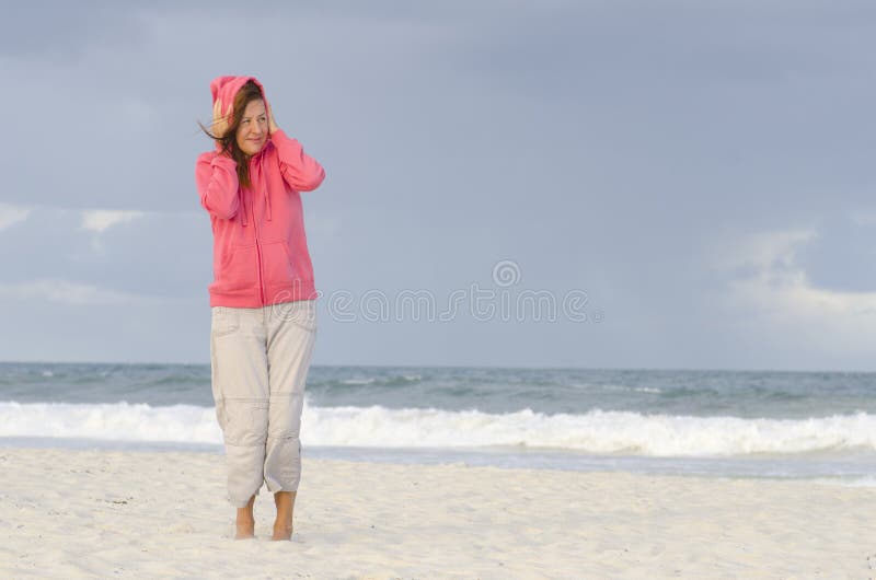 Woman at autumn weather at beach