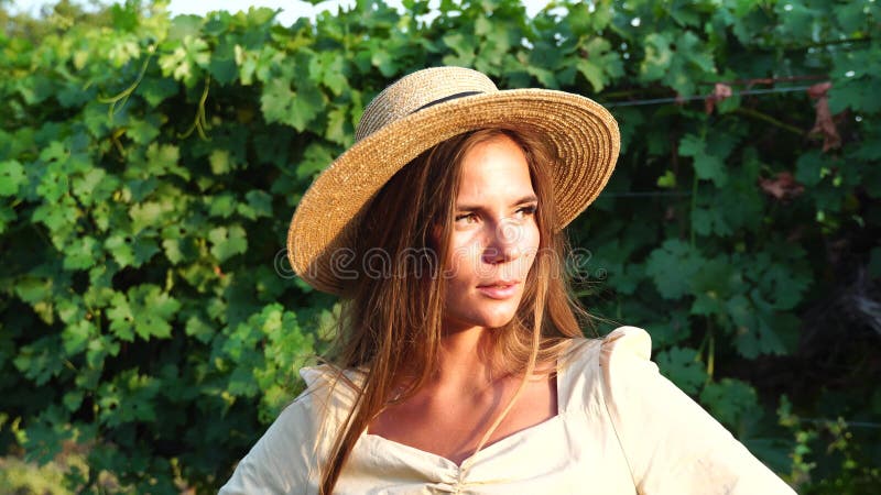 Woman at autumn winery. Portrait of happy woman holding glass of wine and enjoying in vineyard. Elegant young lady in