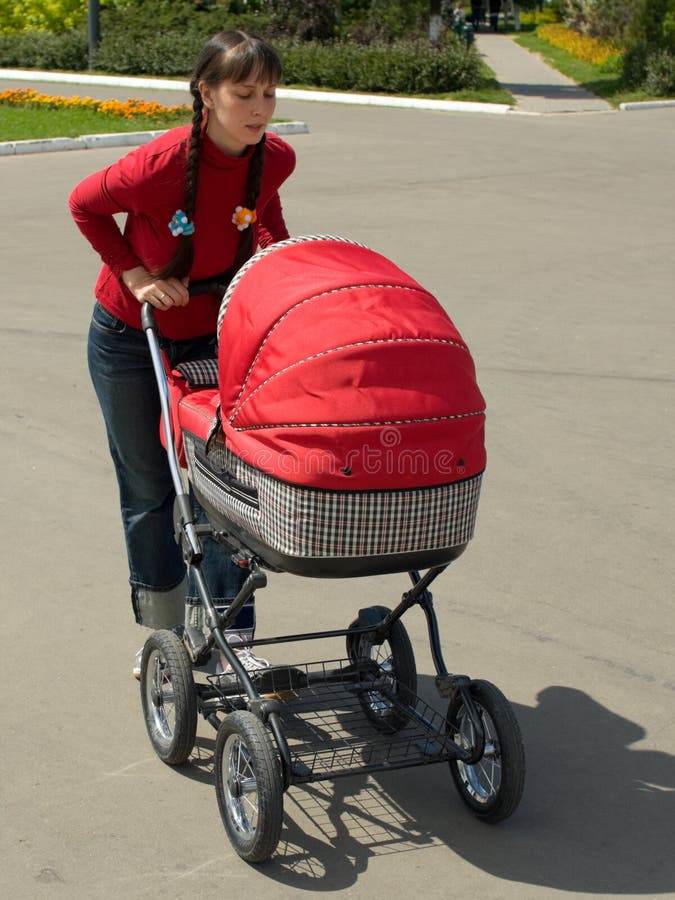 Woman with baby carriage stock image. Image of people 6189195