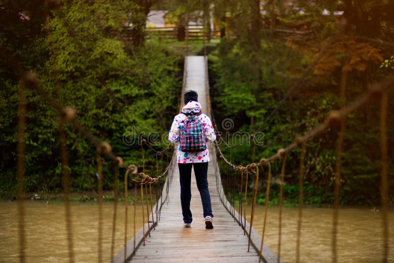 Woman with backpack hiking Lifestyle adventure concept forest and cross river in forest active vacations royalty free stock photography Woman with backpack hiking Lifestyle adventure concept forest and cross river in forest active vacations royalty free stock photography