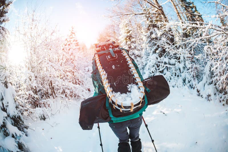 Woman With Backpack And Snowshoes In The Winter Mountains ...