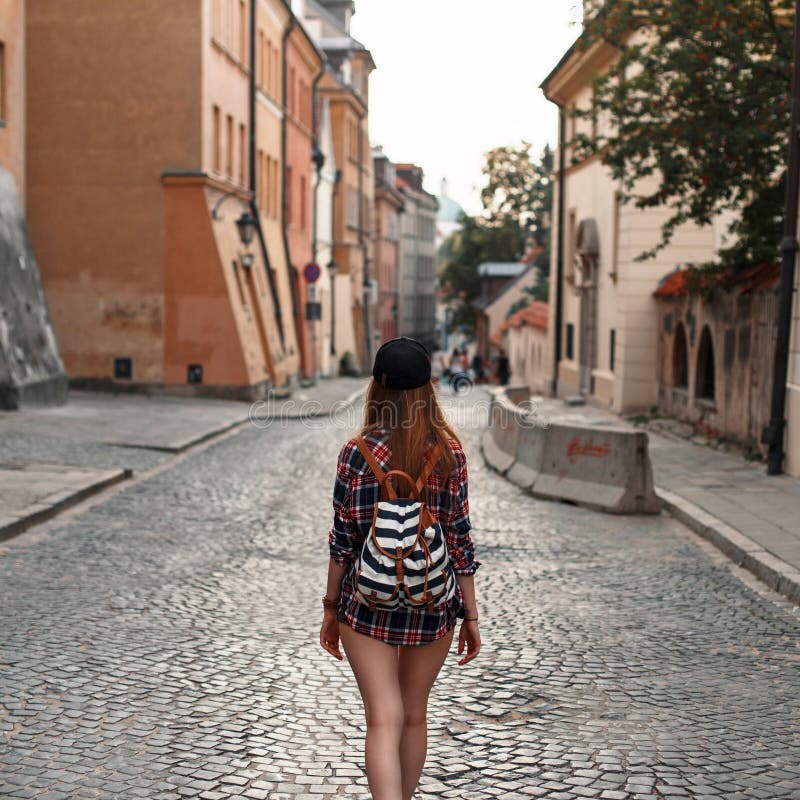 Woman with a backpack walking around the city. Euro-trip. stock photo Woman with a backpack walking around the city. Euro-trip. stock photo