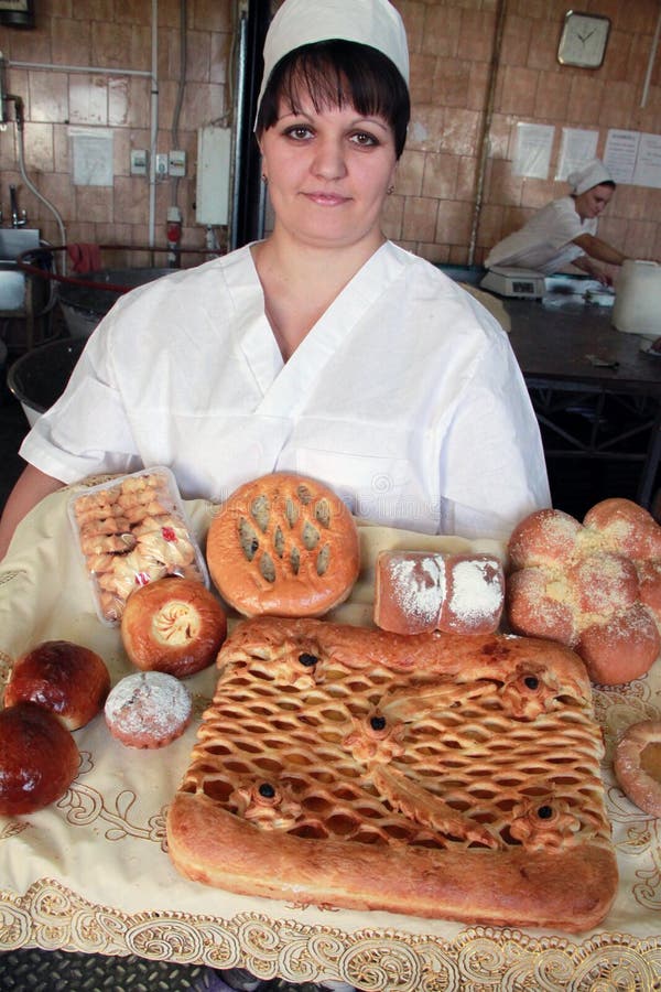 Woman baker with bread products in bakery stock images Woman baker with bread products in bakery stock images