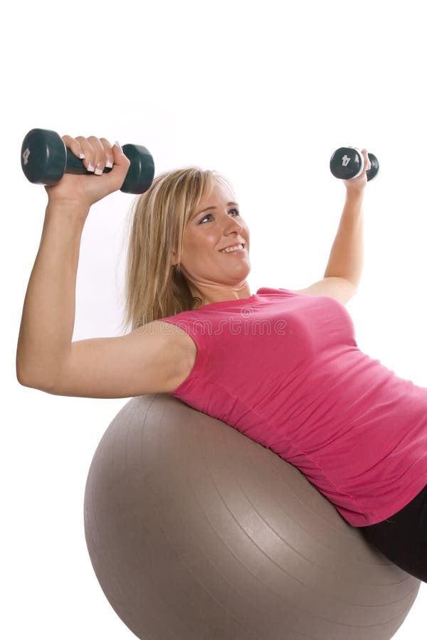 Woman on ball with weights