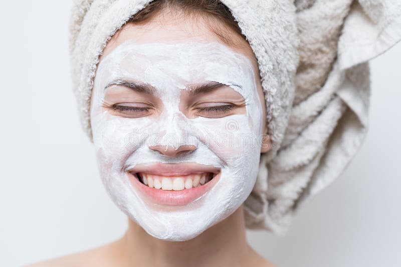 woman with bare shoulders towel on head face mask skin care close-up