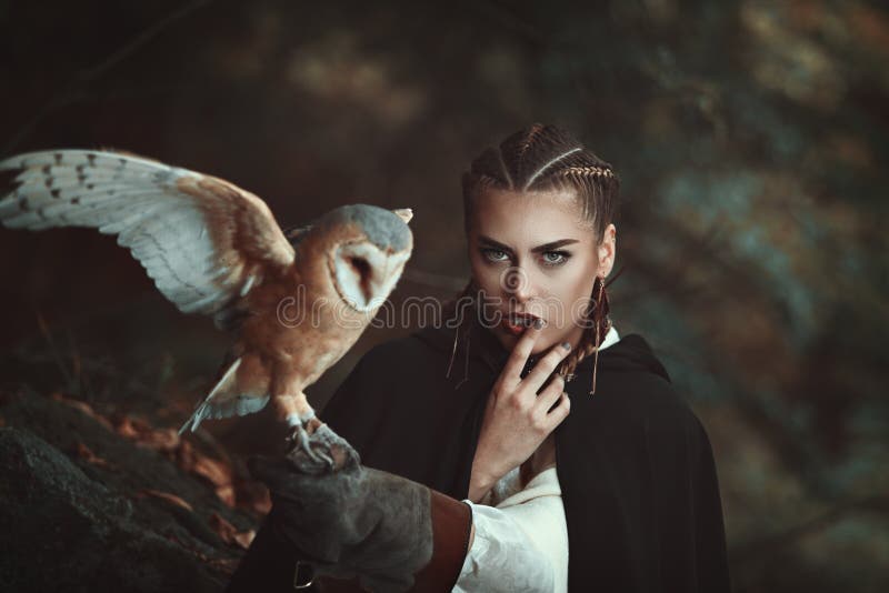 Woman with barn owl on her arm