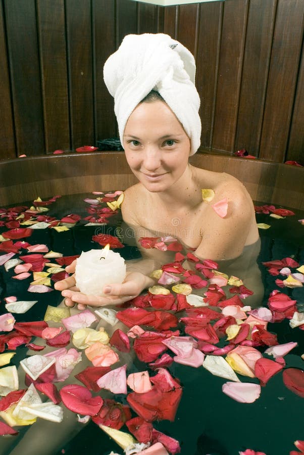 Woman Bathing in Flowers Holding Candle-Vertical