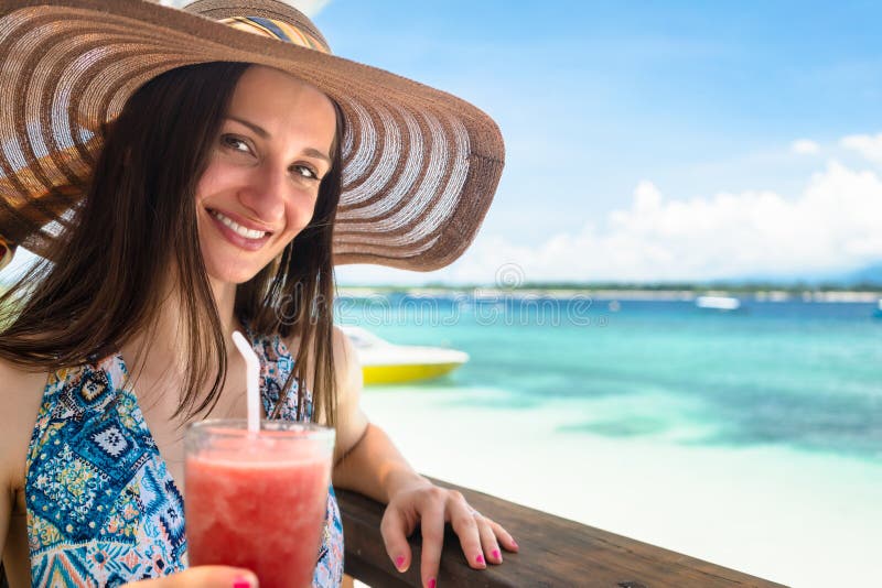 Woman in beachwear enjoying drink in beach cafe at sea royalty free stock photo Woman in beachwear enjoying drink in beach cafe at sea royalty free stock photo