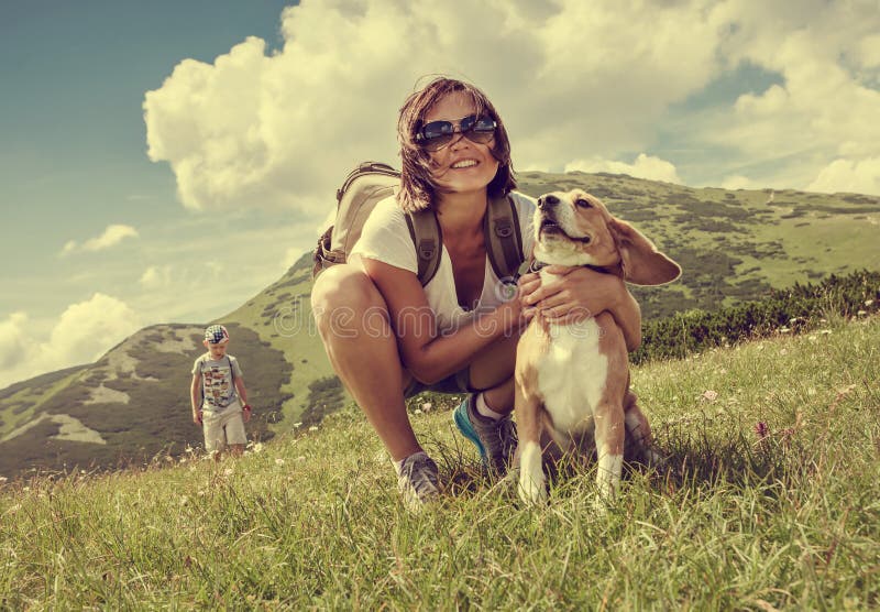 Woman with beagle on mountain hill