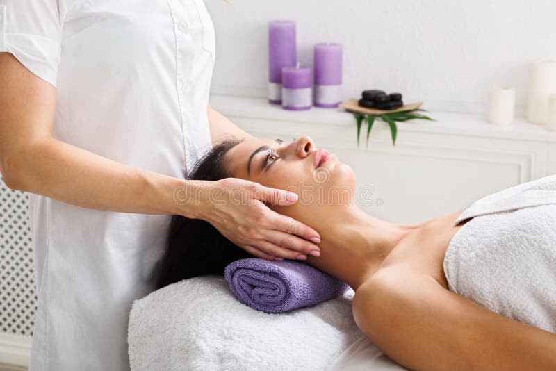 Woman Beautician Doctor Make Head Massage In Spa Wellness Center Stock